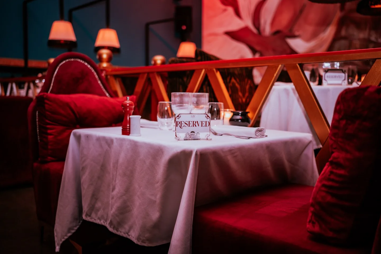 A reserved card on a set table in the red dining room at LOV in Founty
