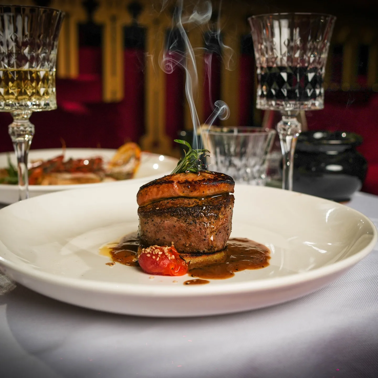 Beef fillet plated with sauce and served under glass at LOV