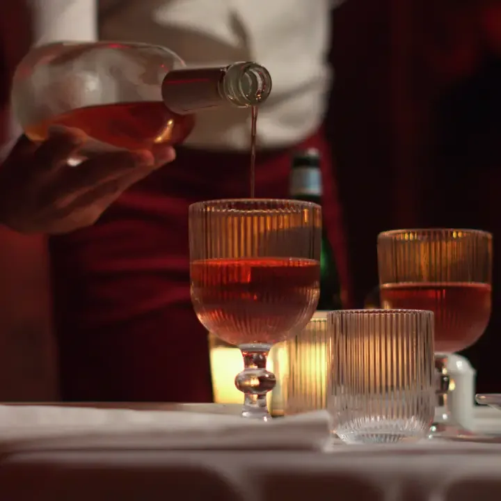 Wine being poured at a candlelit LOV table
